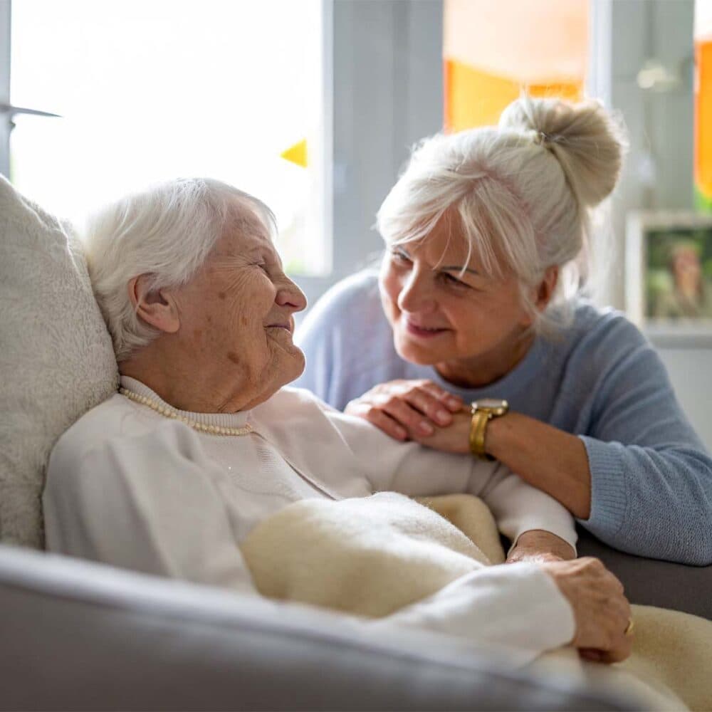 Daughter discussing home care options with her elderly Mum