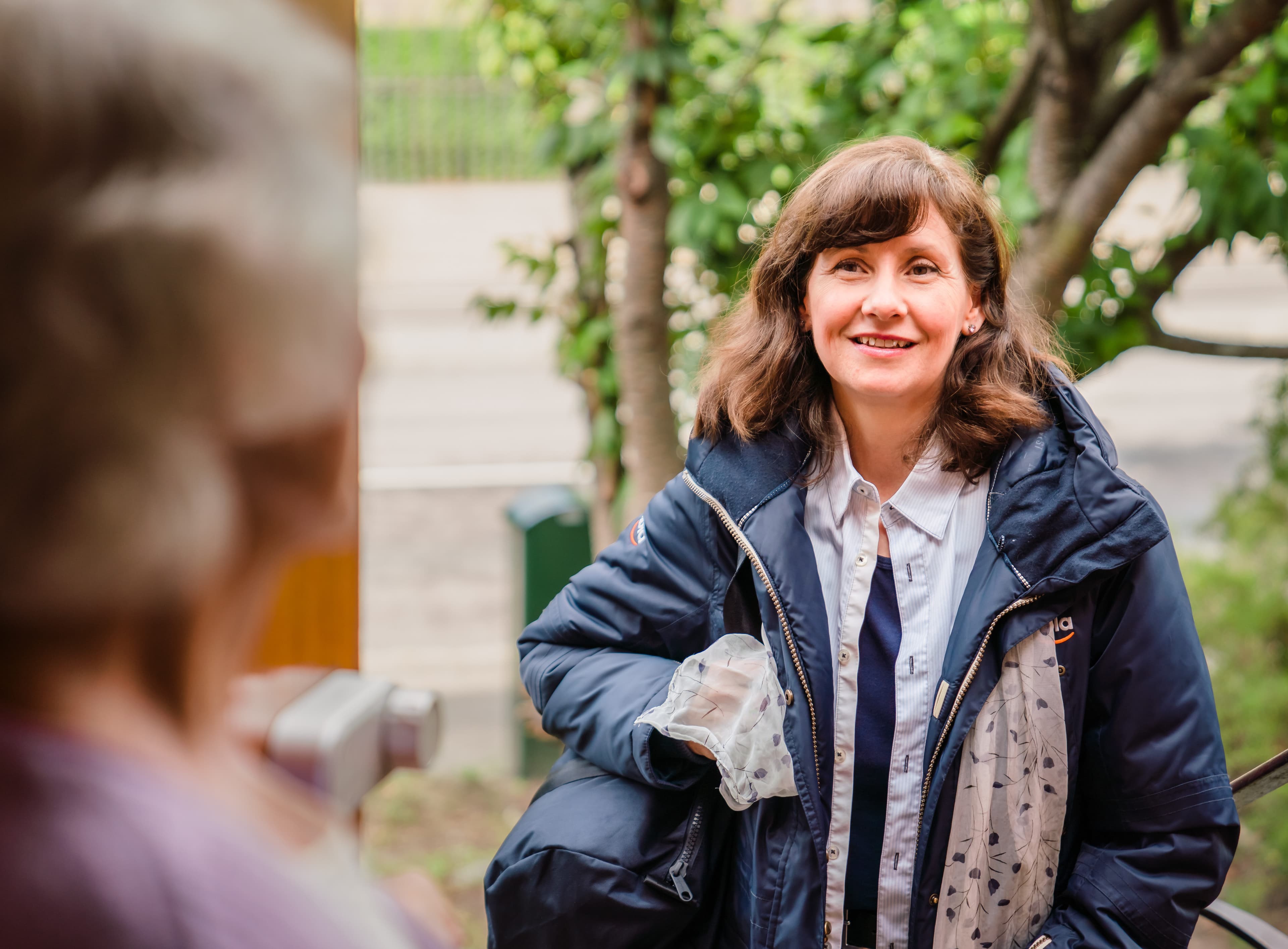 Home Instead live-in carer arrives and is greeted by her client at the front door