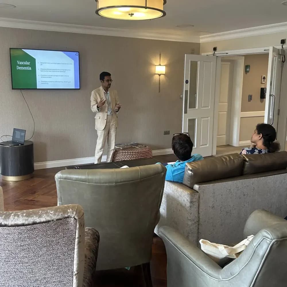 Dr Suhail Hussain speaking to visitors at Home Instead Watford's Spot the Signs dementia awareness event