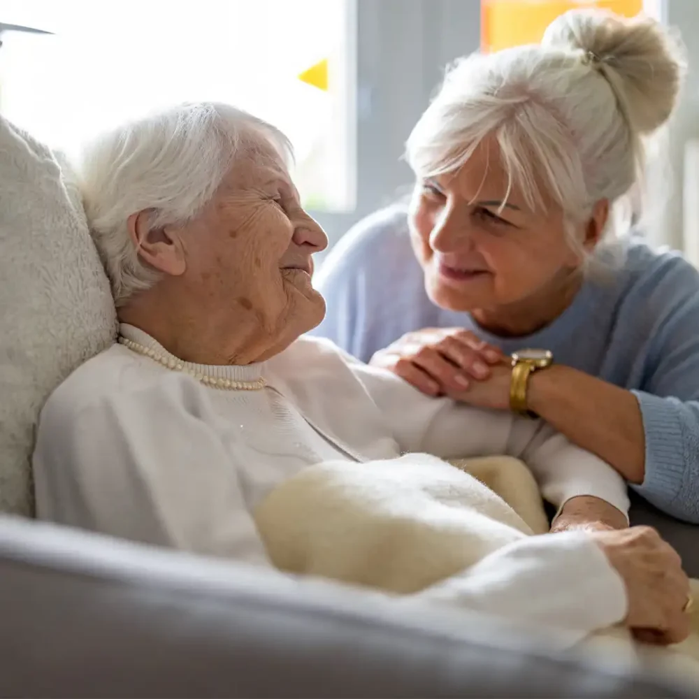Care Professional sat next to her client enjoying time chatting