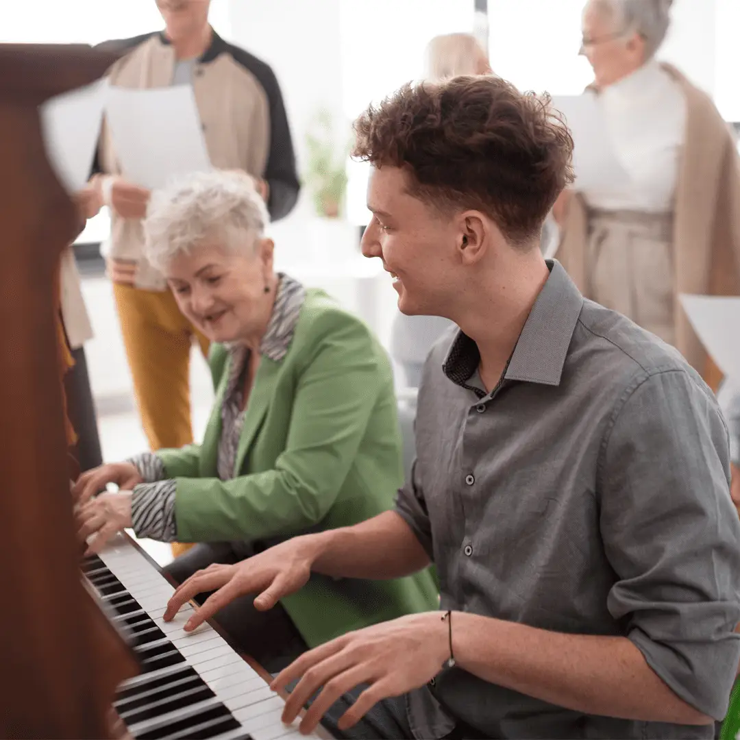 Older Lady playing piano at singing for the brain watford